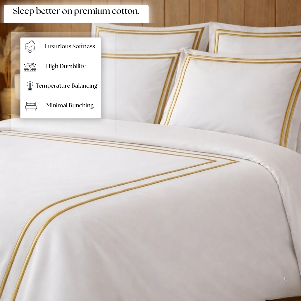 White bedding set with gold accents on a bed, featuring text about premium cotton benefits.