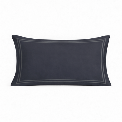Navy blue pillow with decorative trim on a white background
