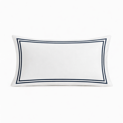 White pillow with navy blue border on a white background