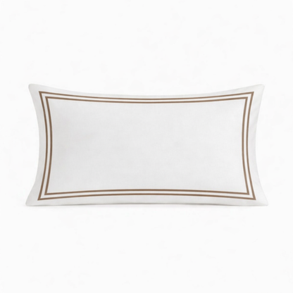White pillow with brown trim on a white background