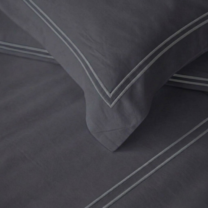 Navy Blue pillows with blue trim on a matching fabric background